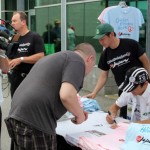 Takuma Sato Signing Shirts for Children Mending Hearts & With You Japan Charities